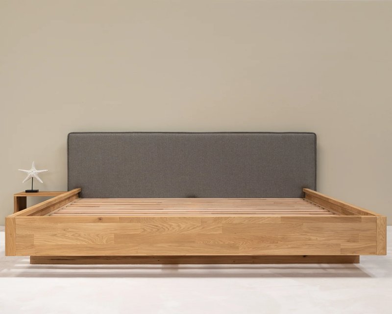 Solid oak bed with gray upholstered headboard